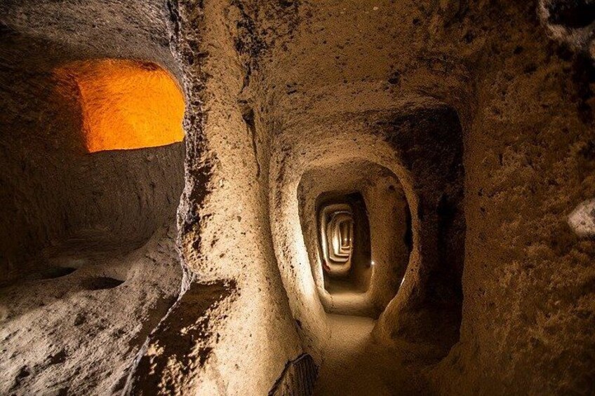 A cave with a spiral tunnel and a glowing orange rock. 2