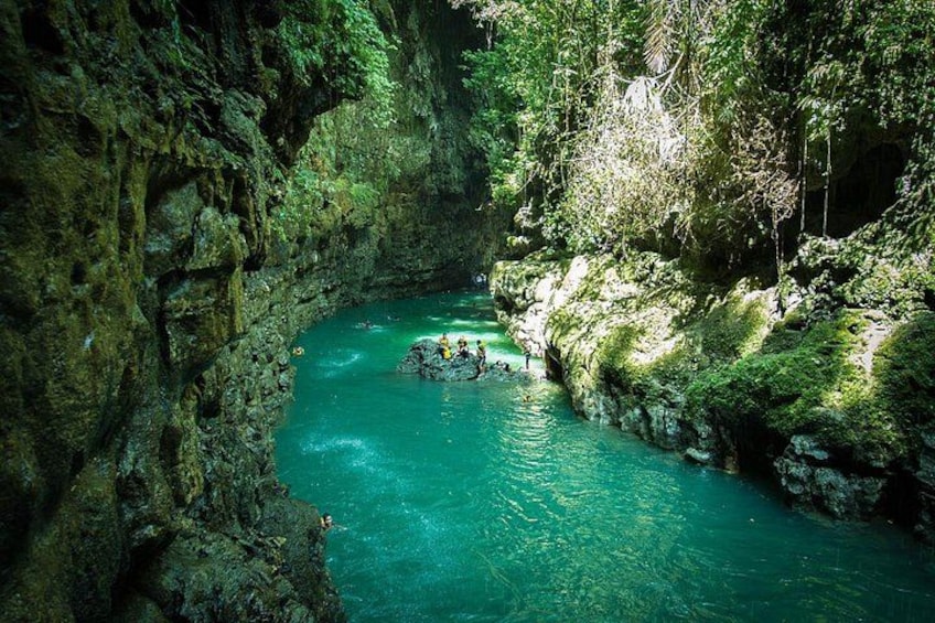 A river flowing through a rocky canyon with lush greenery on the banks. 1