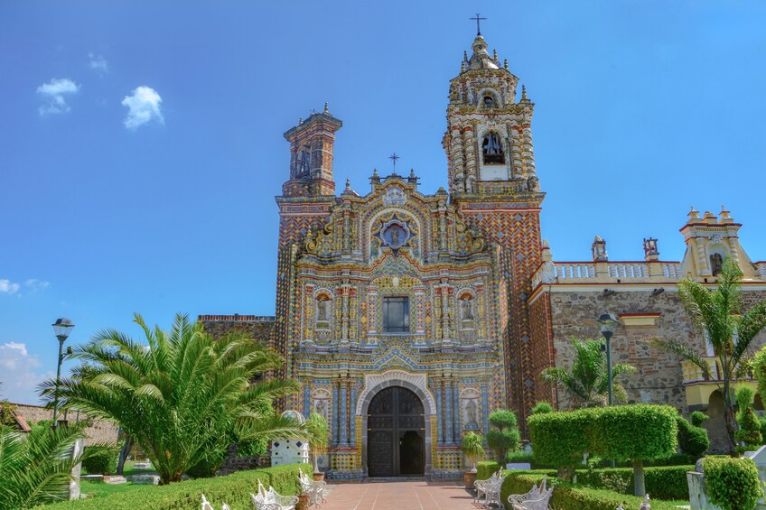 A colorful church with intricate tile work and a bell tower. 3