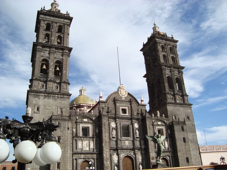 A historic cathedral with two prominent towers, a large dome, and intricate architectural details. 2