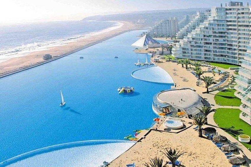 A coastal resort with a marina, beachfront, and modern buildings. 2