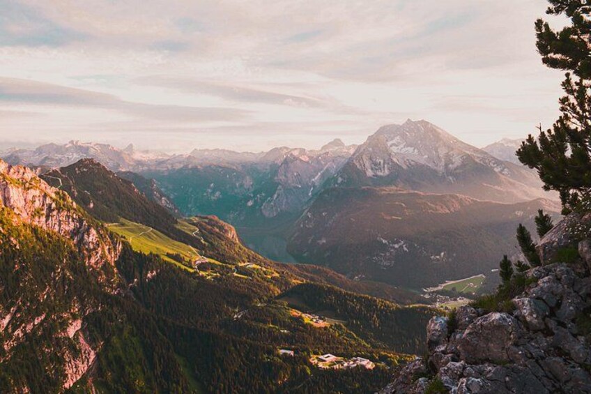A mountainous landscape with a valley, rocky outcrops, and a prominent peak. 2