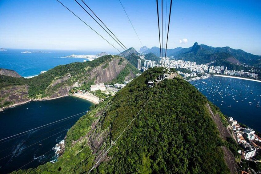 A cable car system, a coastal city, and a mountainous landscape. 2