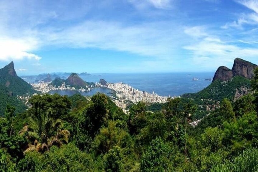 A cityscape with mountains and lush greenery. 3