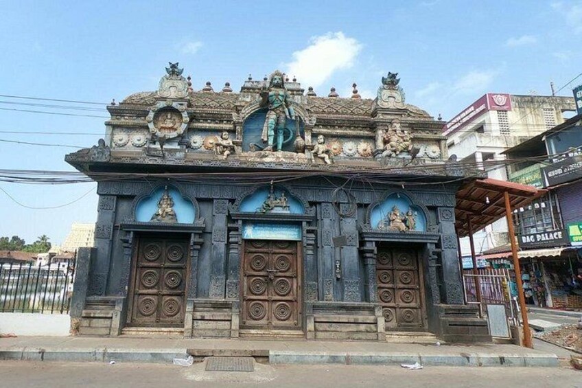 A temple with ornate carvings and statues, featuring a prominent deity figure. 5