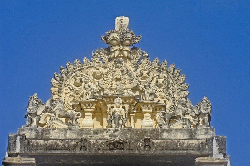 A detailed stone structure with ornate carvings and statues. 3