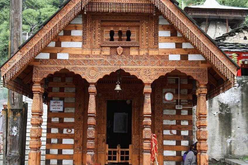 A traditional wooden structure with intricate carvings and a bell. 5