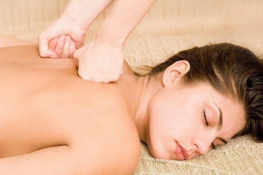 A person lying down with hands being massaged. 4