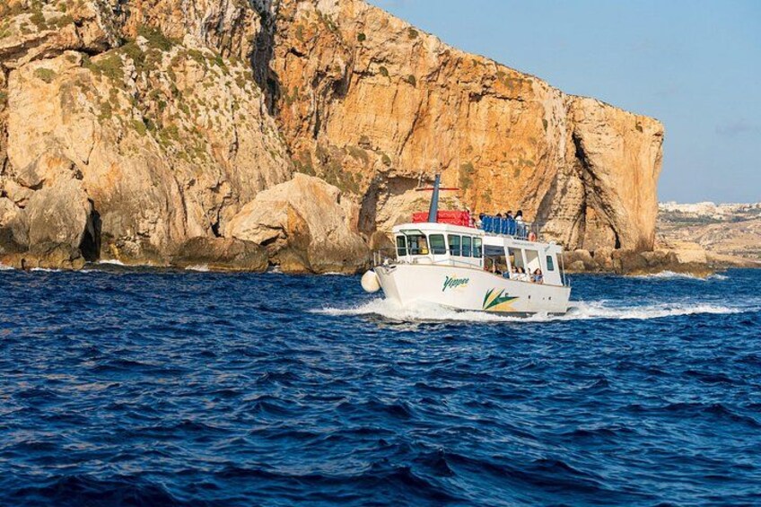 A boat with passengers on a rocky coastline. 3
