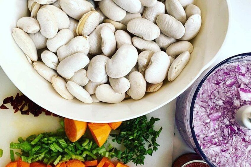 A bowl of white beans, chopped carrots, and parsley. 3