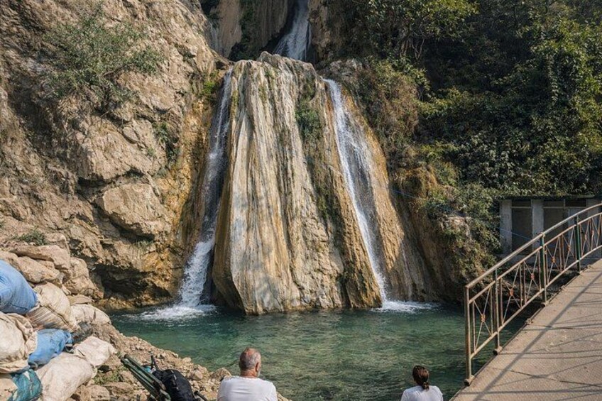 Waterfall retreat with visitors and bridge 5