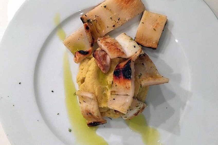 A white plate with grilled chicken pieces and a yellow sauce. 3