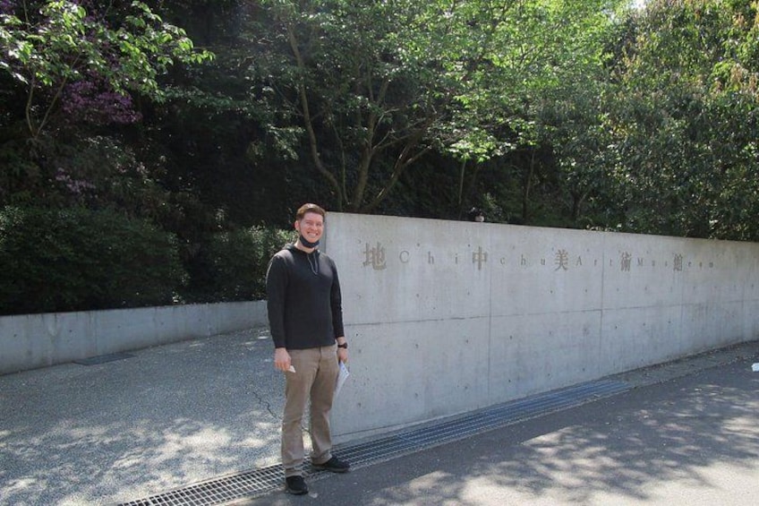 A person standing in front of a wall with foreign writing. 4