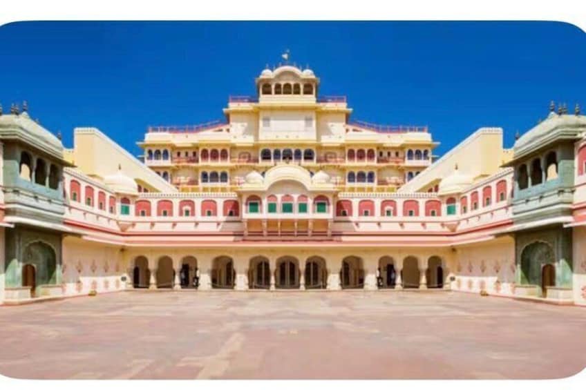 A large, multi-tiered building with a central courtyard, surrounded by arches and balconies. 3