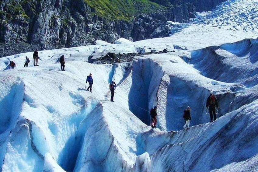 A glacier with people hiking on it. 1