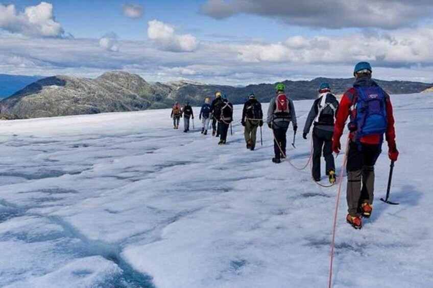 A group of people hiking on a snowy mountain trail. 4