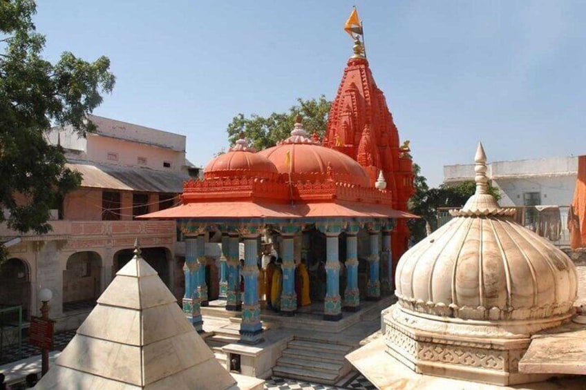 A temple with a red spire and a white dome. 1