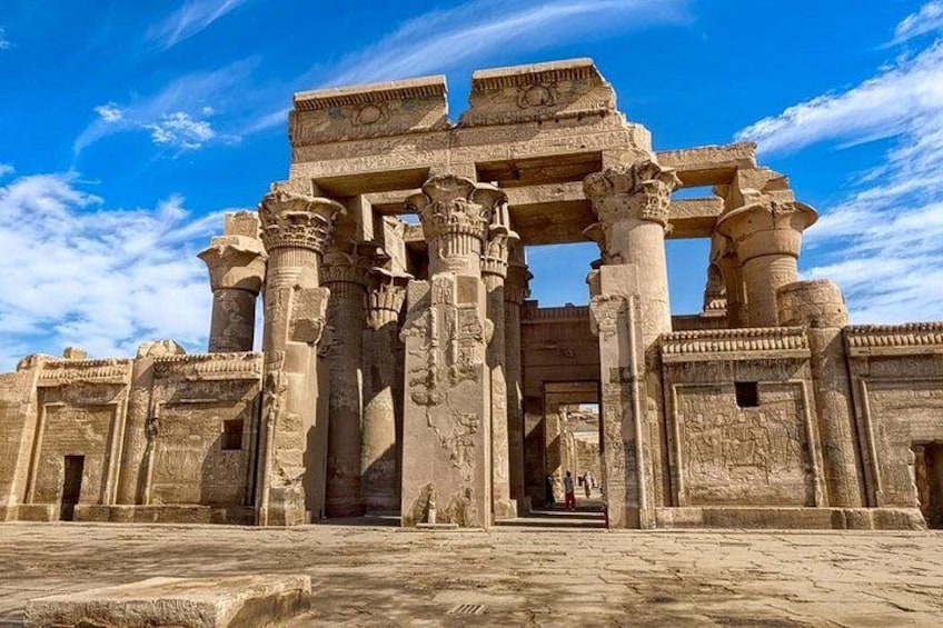 Ancient stone ruins with columns and intricate carvings. 2