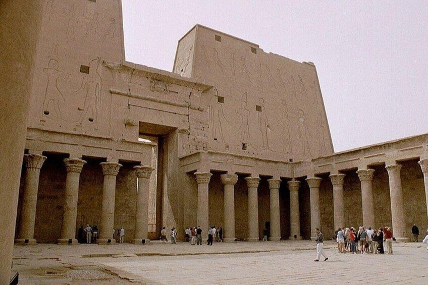 An ancient Egyptian temple with large columns and hieroglyphs. 1