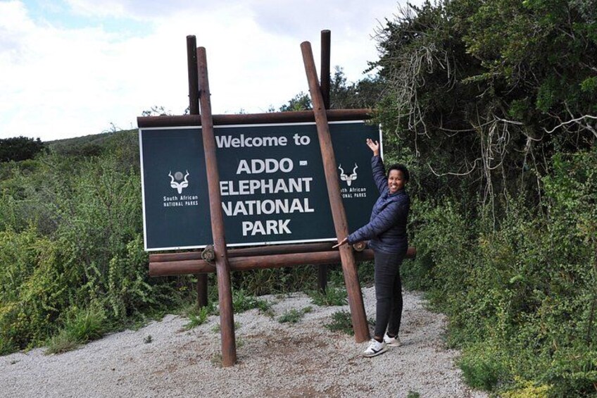 Tourist posing at a board sign of Addo Elephant National Park 4