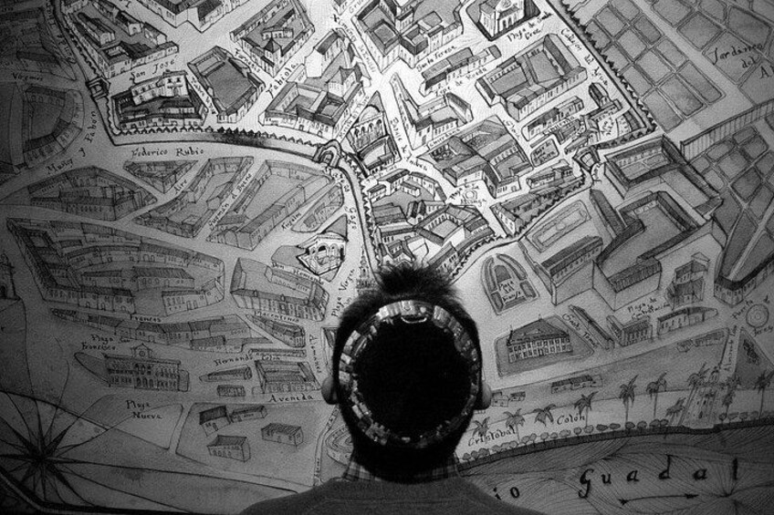 A detailed map with a person standing in front of it. 3
