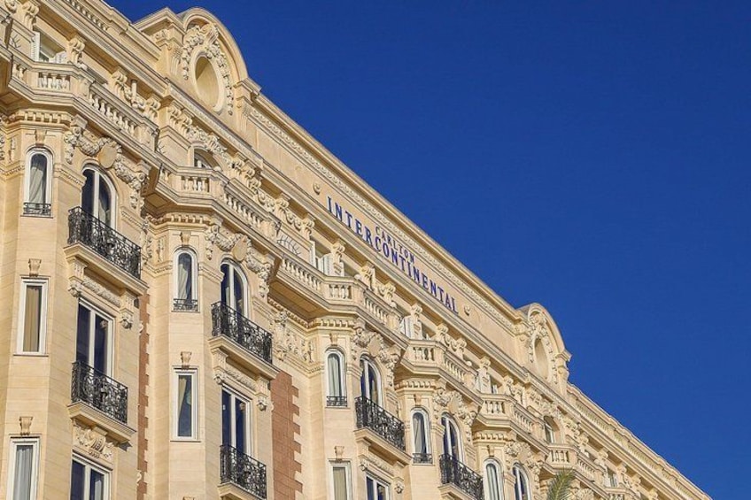 A historic building with ornate architecture, including multiple balconies and decorative moldings. 4