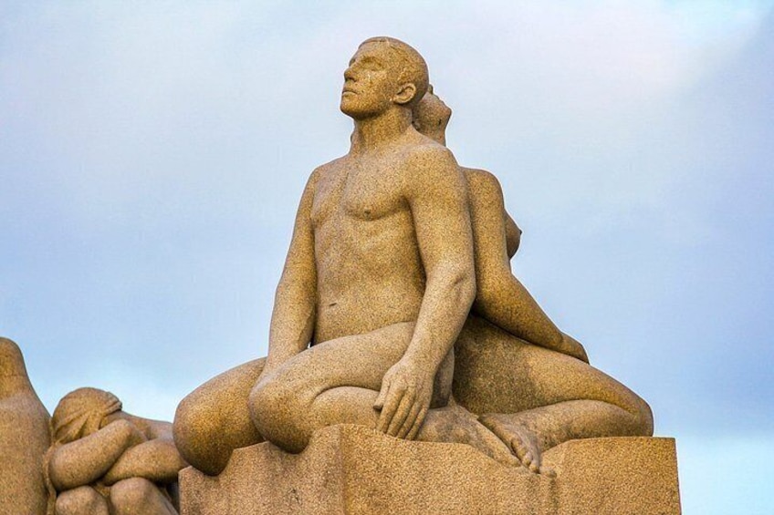 A large stone sculpture of a reclining human figure. 4