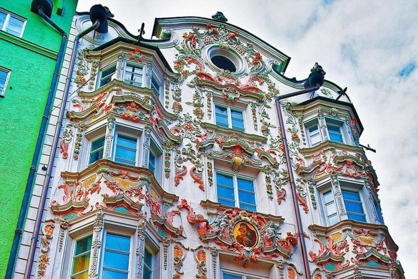A building with ornate architectural details, including multiple windows and decorative elements. 4