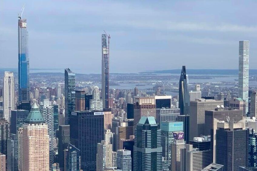 A cityscape with numerous high-rise buildings, including a distinctive skyscraper with a pointed top and another with a curved facade. 4