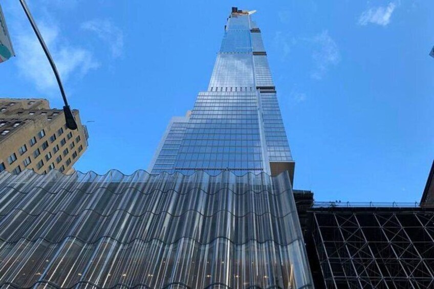 A tall skyscraper with a glass facade and a pointed top. 5