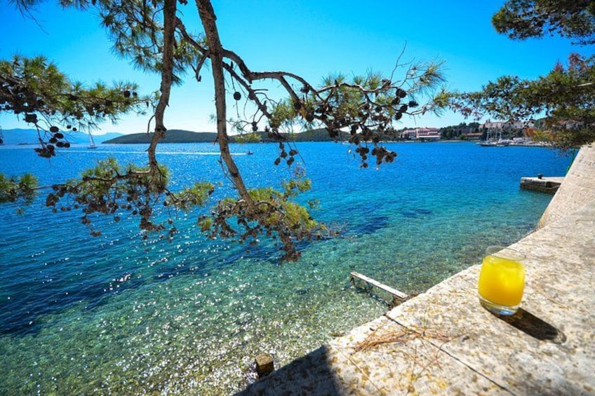 A clear blue sea, a wooden dock, and a yellow object on the dock. 4