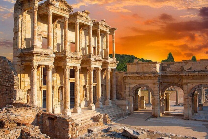 Ancient ruins with columns and arches, set against a sunset sky. 5