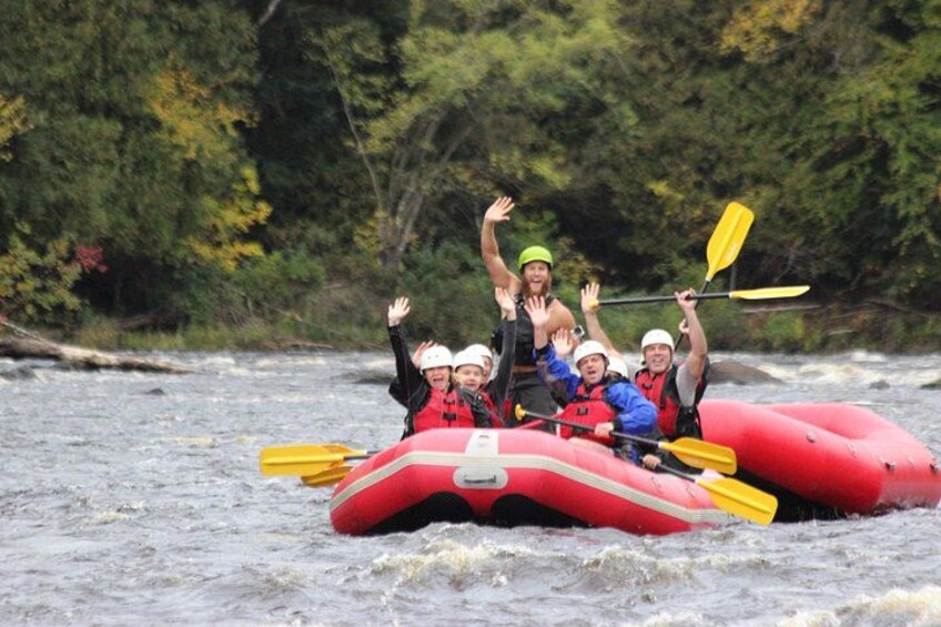 A group of people rafting on a river surrounded by dense forest. 5