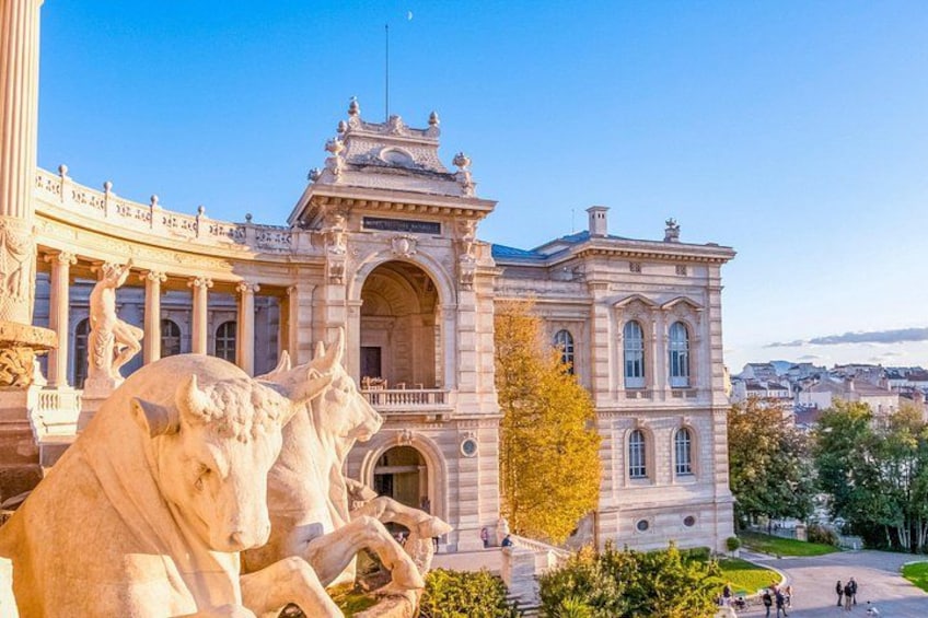 A large, ornate building with classical architecture, including columns and statues. 1