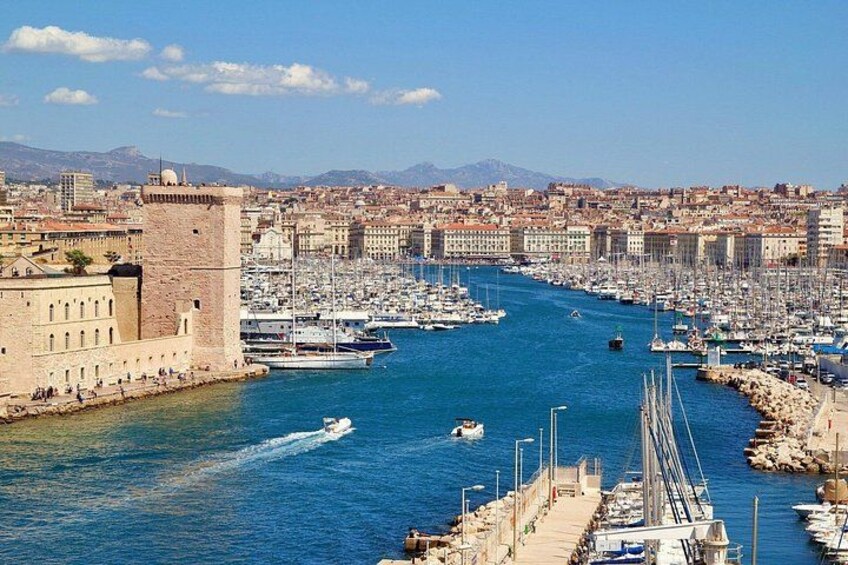 A harbor with boats, a bridge, and historic buildings. 3