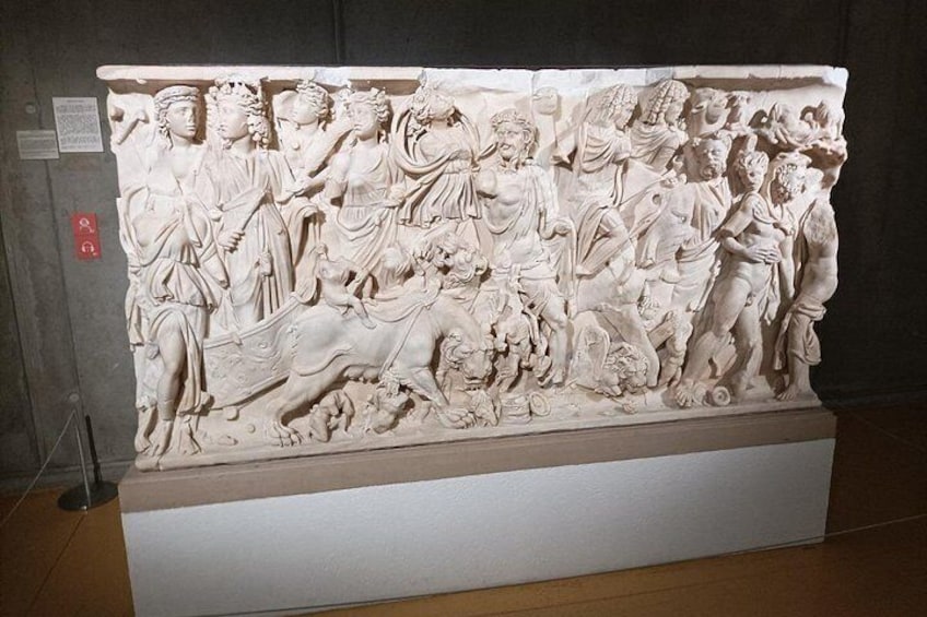 A detailed marble relief sculpture with figures, animals, and inscriptions. 4