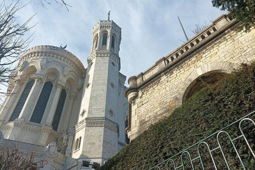 A historic stone building with a bell tower and arched windows. 2