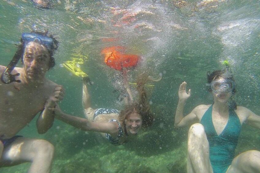 People snorkeling underwater. 5