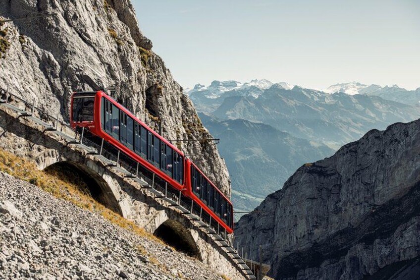 A red cable car on a mountain track. 5