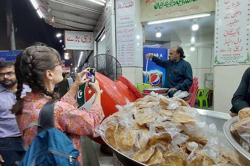 A street food stall with a variety of fried items on display. 4