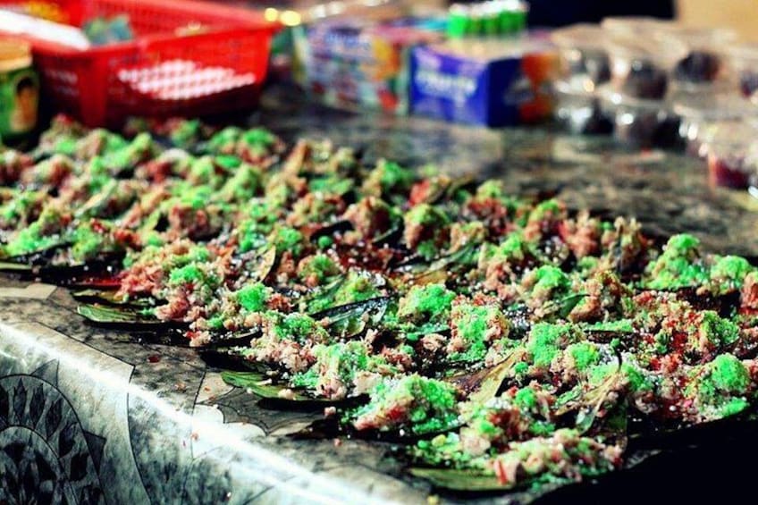 A food stall with skewers of meat and vegetables. 2