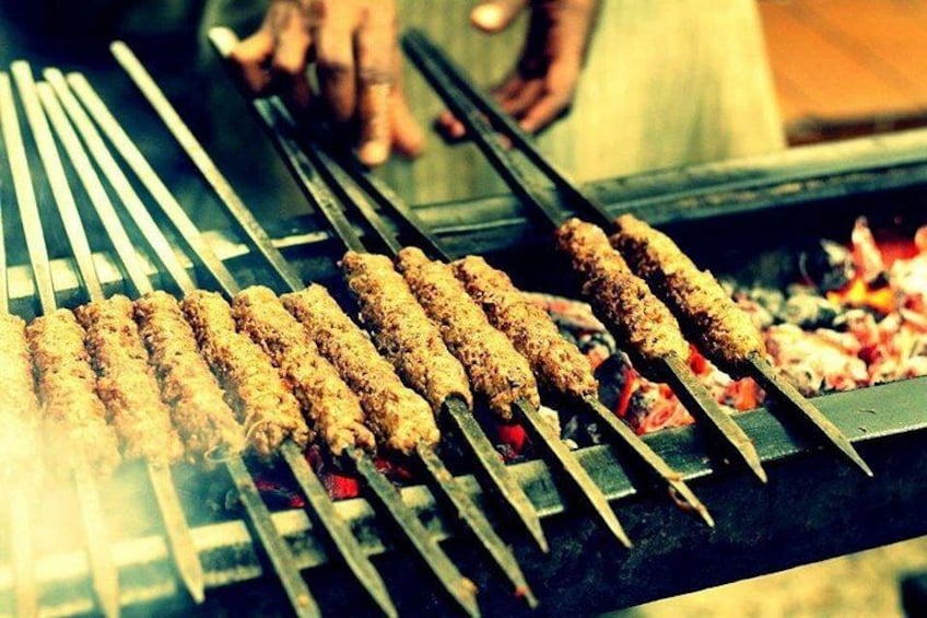 Skewers of food being grilled on a barbecue. 5