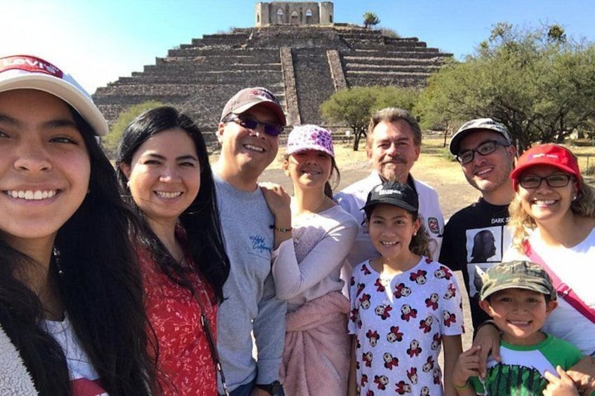 A group of people in front of a large ancient pyramid. 5