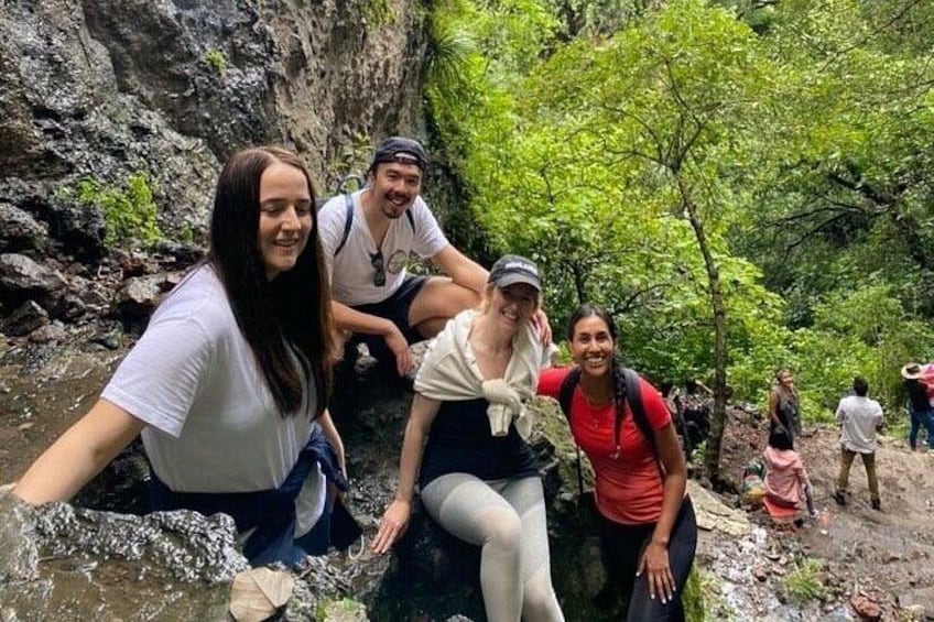 A group of people climbing a rocky waterfall. 2