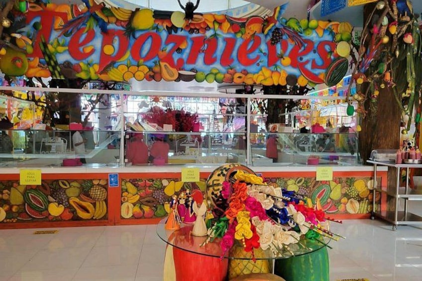 A colorful fruit stand with a variety of fruits and vegetables displayed. 4