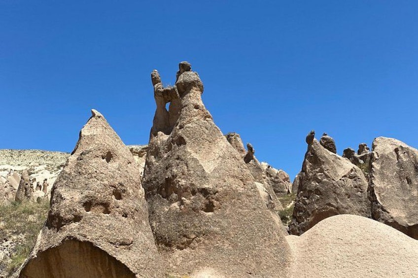 Rock formations with sharp peaks and a clear blue sky. 4