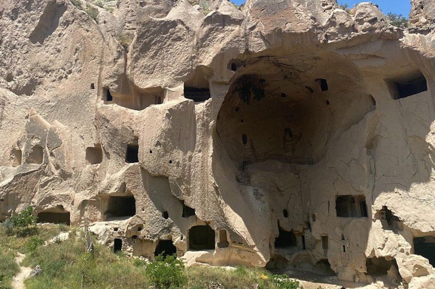 A rock formation with multiple caves and openings. 5
