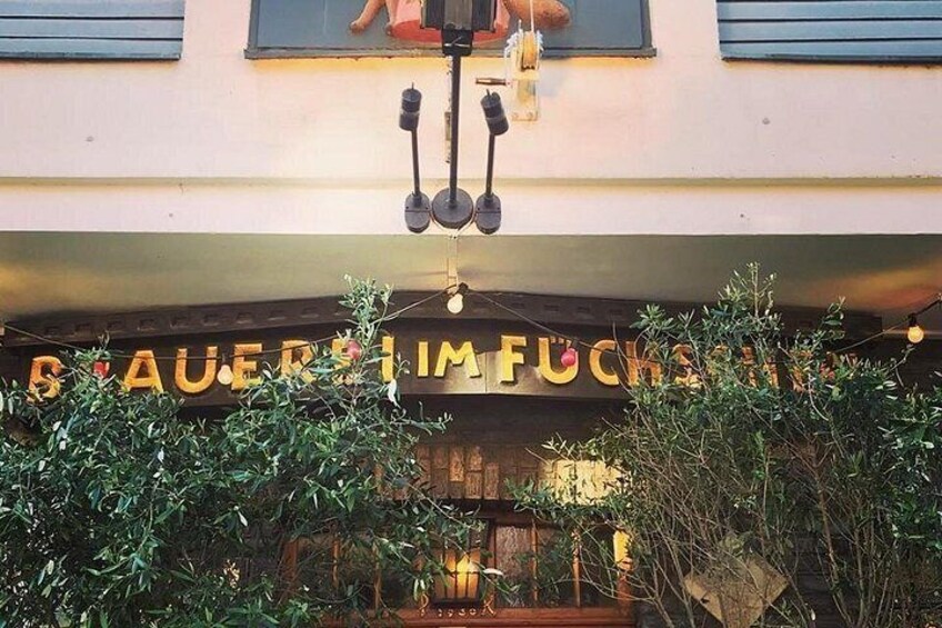 A building with a sign that reads 'AUER IM FUCHS.' 3