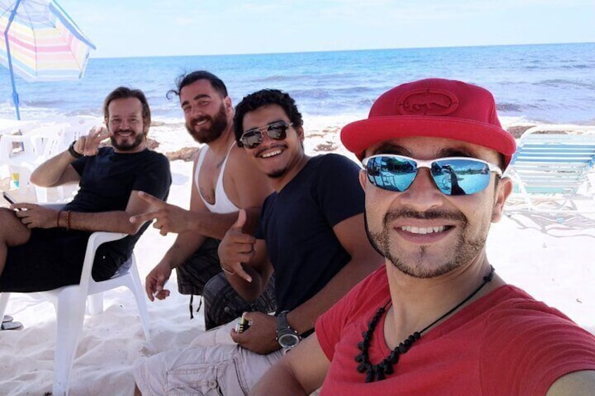 A group of people on a beach with the ocean in the background. 1