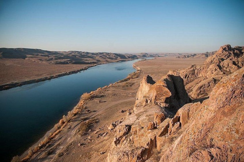 A river winding through a rocky landscape with a clear sky. 2